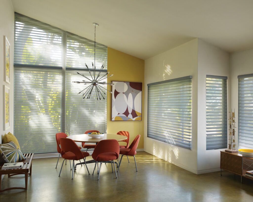 A dining room with red chairs and yellow walls.